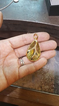 Custom gold setting for a customer supplied gemstone